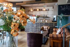 a vase filled with flowers on a table in a store at The Loopy Shrew in Shrewsbury +9 photos