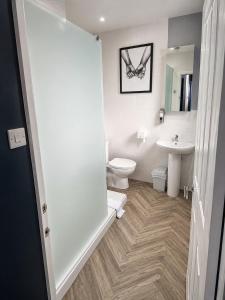 a bathroom with a toilet and a sink at The Stables in Market Rasen