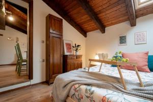 a bedroom with a bed with a table on it at Una mansarda in montagna in Fanano