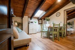 a living room and dining room with a table and chairs at Una mansarda in montagna in Fanano +8 photos
