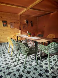 a room with a table and chairs on a tiled floor at Vikendica Jagodica in Ivanjica