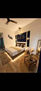 a bedroom with a large bed and a coffee table at Aashirwad Retreat in Greater Noida