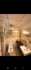 a bathroom with a toilet and a sink at Aashirwad Retreat in Greater Noida