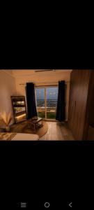 a bedroom with a large window with a view at Aashirwad Retreat in Greater Noida