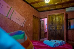 a room with a bed with blue pillows on it at Kasbah Imlil in Imlil