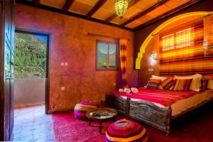 a bedroom with a bed in a room with a window at Kasbah Imlil in Imlil