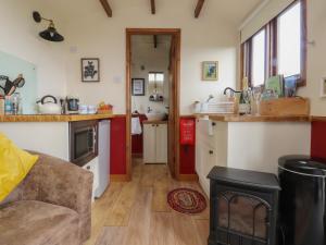 a kitchen with a sink and a counter top at The Herdsman Luxury Shepherds Hut in Barnoldswick +17 photos