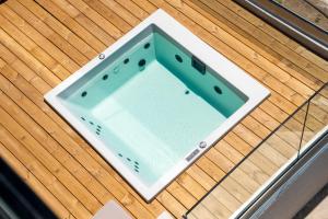 a glass table on top of a wooden deck at enplomare in Plomari