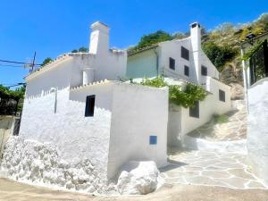a white building on top of a hill at 2-Bed Country House - Mountain Views - Sleeps 6 in Rute
