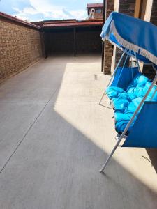 a blue chair sitting on top of a patio at Emara Lodge Bansko in Bansko +26 photos