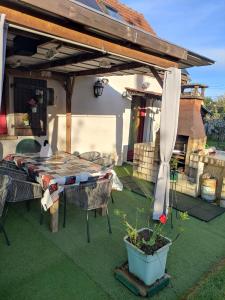 a patio with a table and chairs under a pergola at La Désirade in Montmirail