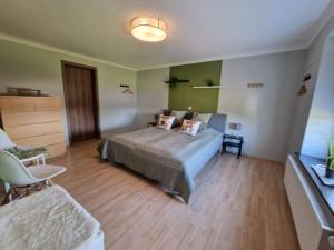 a bedroom with a bed and a table and chairs at Eiflia- Im Warchetal in Bullange