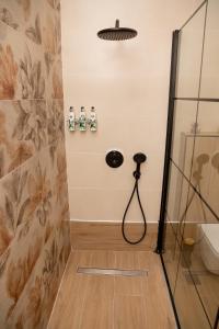 a bathroom with a shower and a sink at Linovrochi holiday house with private pool in Lefkandi Chalkidas +20 photos