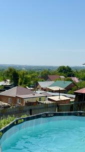 a large swimming pool with a view of a city at House on the mountain in Ustʼ-Kamenogorsk