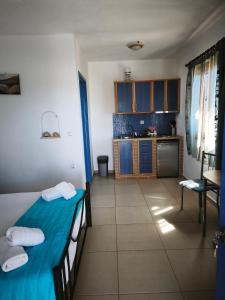 a small room with two beds and a kitchen at Ammoudia Studios in Agiassos +45 photos
