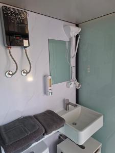 a bathroom with a sink and a phone on the wall at Unseburger-Brauhaus GmbH, FW 10 in Unseburg +5 photos