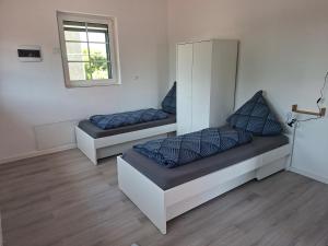 two beds with blue pillows in a room at Unseburger-Brauhaus GmbH, FW 10 in Unseburg