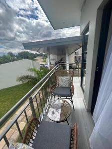 a balcony with chairs and a table on a balcony at Millenium Heights Borrowdale in Harare