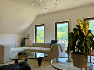 a living room with a couch and a table at Ferienhaus Burgblick am Hang in Bernkastel-Kues