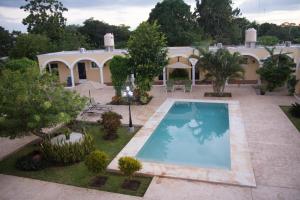 an aerial view of a house with a swimming pool at Hotel Hacienda de Izamal in Izamal