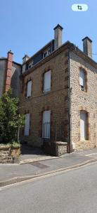a brick building with white windows on a street at La belle époque ardennaise in Sedan