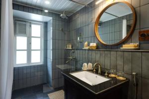 a bathroom with a sink and a mirror at Singell Tea Estate - A CGH Earth Experience in Darjeeling