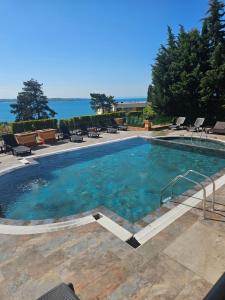a large swimming pool with blue water at Византия in Sozopol
