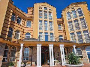 a large building with a balcony in front of it at Византия in Sozopol
