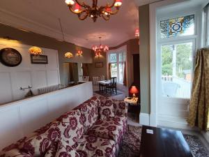 a living room with a couch and a dining room at The Vicar's View at the Old Vicarage in Lincoln