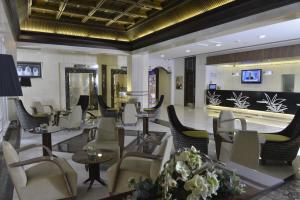 a lobby with chairs and tables and a bowling alley at Golden Tulip Bahrain in Manama