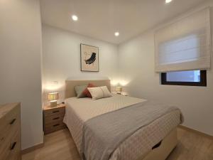 a bedroom with a large bed and a window at Apartamentos Mar-Sol Villas in Vilamoura
