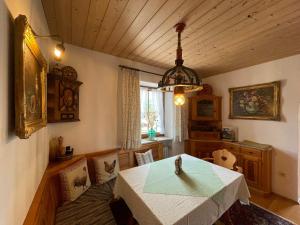 a dining room with a table and a chandelier at Haus Lukaswinkl in Schönau am Königssee