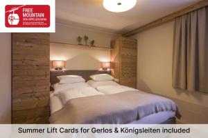 two beds in a hotel room with a sign that reads summer lift cards for c at Apartment Gerlos 183 in Gerlos