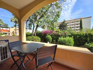 a table and two chairs on a balcony with a table and a table at Apartamentos Mar-Sol Villas in Vilamoura