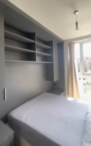 a bedroom with a white bed and a window at Harrow Nest - 1Bedroom in Hatch End