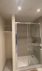 a shower with a glass door in a bathroom at Harrow Nest - 1Bedroom in Hatch End