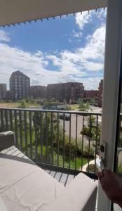 a room with a balcony with a view of a city at Harrow Nest - 1Bedroom in Hatch End