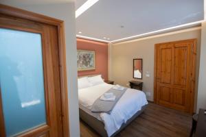 a bedroom with a bed and a large window at Vila e Mjeshtrit in Korçë