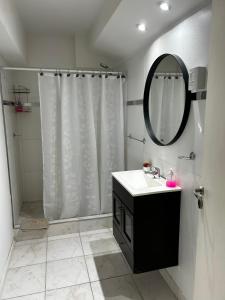 a bathroom with a sink and a shower with a mirror at Apart Luro VI in Santa Rosa +18 photos