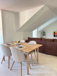 a wooden table and chairs in a living room at Adriatic Retreat Mljet in Polače