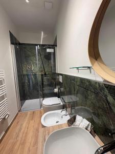 a bathroom with a toilet and a sink and a shower at Cindy Cottage Holiday Home in Giuncarico
