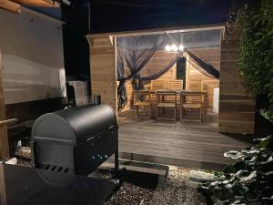 a patio with a grill and a table and chairs at 蔵Mping Hotel in Fukaya