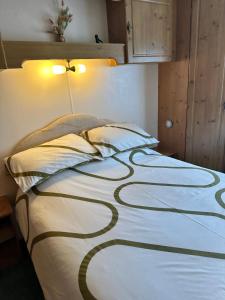 a bedroom with a bed with a bedspread with a design on it at Cosalt Sea View 18 in Ardentinny