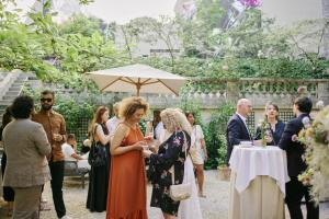 a bride and groom standing under an umbrella at a ceremony at Hôtel Alfred Sommier in Paris