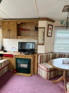 a living room with two couches and a tv at Cosalt Sea View 18 in Ardentinny +13 photos