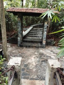 a set of stairs with a pavilion in a garden at Makelioya Nature Resort in Kelinkanda