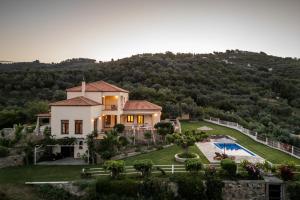 an aerial view of a house with a pool at Villa Anatoli in Skopelos Town