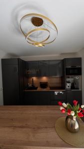 a kitchen with a table with a vase of flowers at Sous les Capucines in Saint-Gervais-les-Bains