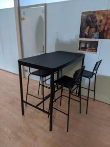 a black table and chairs in a room at Private Room in a shared apartment in Odense