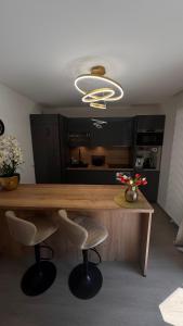 a kitchen with a large wooden table and chairs at Sous les Capucines in Saint-Gervais-les-Bains
